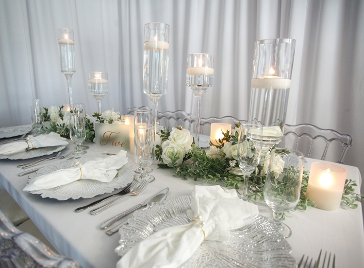 placements at a wedding table with flowers and candles